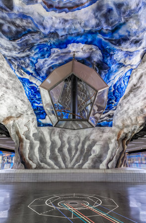 Moning train at the Stockholm underground metro or tunnelbana station Tekniska Hogskolan or Institue of Technology with intricate floor, wall and ceiling designsのeditorial素材