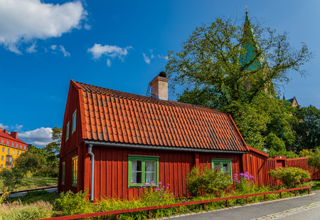 Traditional swedish old house in the heart of Stockholm, Sweden with a church in the backgroundのeditorial素材