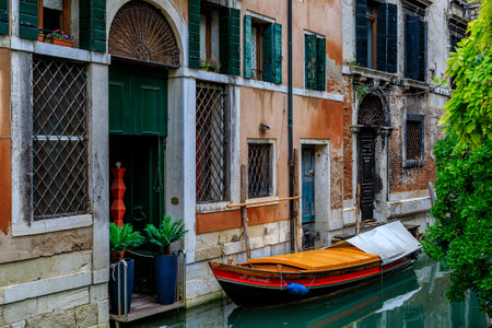 Venice, Italy - September 24, 2017: Boat parked along the picturesque building facades on one of the canalsのeditorial素材