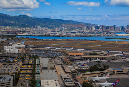Honolulu, Hawaii, USA - May 25, 2015: Aerial view of downtown Honolulu and airplanes parked on the field of Daniel K. Inouye International Airport HNL, formerly known as Honolulu International Airportのeditorial素材