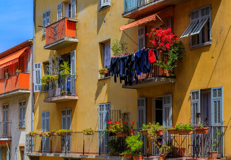 View of traditional mediterranean houses with flowers and laundry drying outside in the streets Old Town of Nice, Franceのeditorial素材