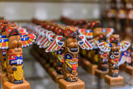 Carved wooden First Nations Native American Indian totem pole souvenirs at a tourist shop in Vancouver Canadaの写真素材