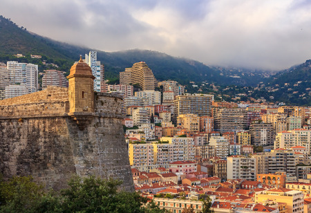 Monaco Monte Carlo skyline view of the residential buildings and mountains with the castle in the foregroundの写真素材
