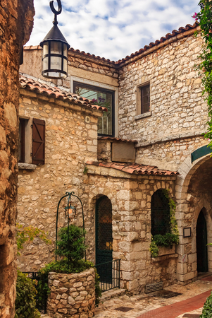 Old buildings and narrow cobblestone streets in a picturesque medieval city of Eze Village in South of France along Mediterranean Seaの写真素材