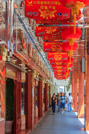 September 14, 2013 -Xiamen, China: Unidentified people walking along a busy shopping street, decorated for the mid autumn festival in center of the cityのeditorial素材