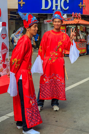 September 14, 2013 -Xiamen, China: Unidentified people in traditional outfits a busy shopping street, decorated for the mid autumn festival in center of the cityのeditorial素材