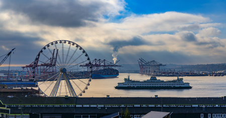 Seattle, United States - November 08, 2018: Seattle waterfront with Great Wheel and the Puget Sound with a ferry boat pulling into a terminal on a cloudy dayのeditorial素材