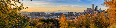 Panoramic view of Seattle downtown skyline  at sunset in the fall with yellow foliage in the foreground from Dr. Jose Rizal Parkの写真素材