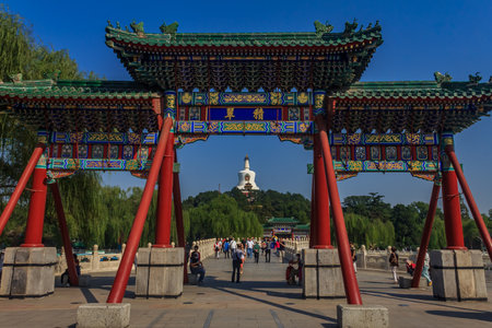 Beijing, China - September 20, 2013: People on Yongan Bridge in Beihai Park with the Jade Island, Bai Ta (White Pagoda or Dagoba) stupa and Buddhist Yong An (Temple of Everlasting Peace) in backgroundのeditorial素材