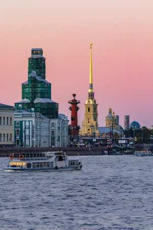Sunset in Saint Petersburg over the Neva river with the view of the Palace Embankment, the Rostral column and the spire of the  Fortress towerの写真素材