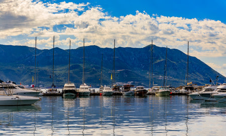 Budva, Montenegro - May 30, 2019: Anchored boats in the port and marina by the medieval Old town on the Adriatic Seaのeditorial素材