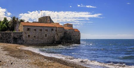 Panoramic view of Budva Old Town Citadel and Adriatic Sea with an outdoor cafe on Richard s Head...