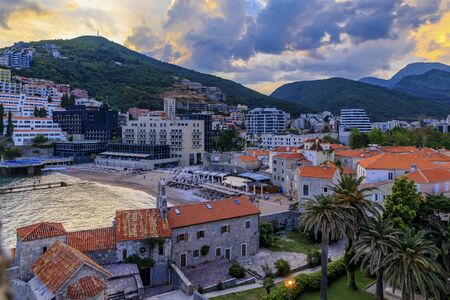 Sunset aerial view of Budva medieval Old Town from the Citadel with the Adriatic Sea with Richard s Head beach in Montenegro, Balkansの写真素材