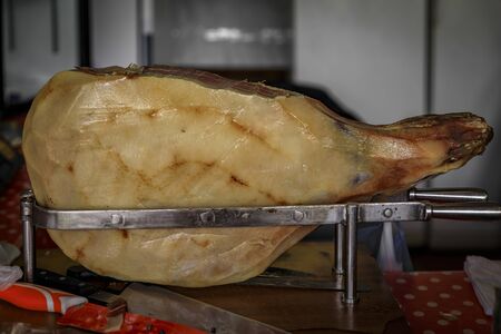 Whole bone-in ham leg of Montenegrin Njeguski prsut cured ham similar to prosciutto and sliced packaged meat on display at market in Kotor Montenegroの写真素材