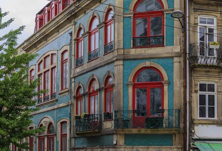 Porto, Portugal - May 31, 2018: Facades of traditional houses decorated with ornate Portuguese azulejo tiles in the streetsの写真素材