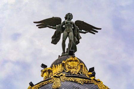 Madrid, Spain - June 4, 2017: Close up of the dome of Metropolis one of the most beautiful buildings on Gran Via street with dramatic blue skyのeditorial素材