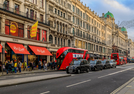 London, United Kingdom - January 13, 2018: Luxury stores on Regent street with people passing by, double decker red busses and black cabs lined upのeditorial素材