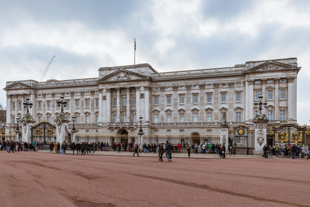 London, United Kingdom - January 13, 2018: Ornate facade of the Buckingham Palace, the royal residence of the British Monarchs with tourists in frontのeditorial素材