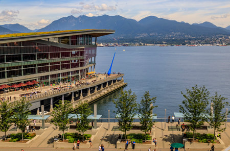 Vancouver, Canada - July 07, 2019: Aerial view of modern architecture at Burrard Landing, Convention Center and the harbor with mountains beyondのeditorial素材