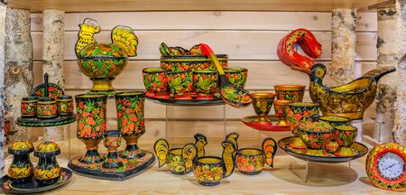 Colorful traditional Russian hohloma or Khokhloma laquer spoons, dishes and cups with a floral motif in a souvenir shop in Saint Petersburg Russiaの写真素材