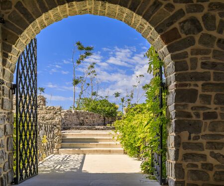 Picturesque stone walls and arched gate of the 15th century Citadel in the Old town in Budva Montenegro in the Balkans on Adriatic Seaの写真素材