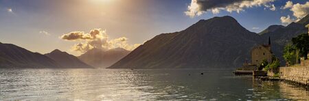 Panorama of Kotor Bay or Boka Kotorska with mountains, crystal clear water and an old stone house in the Balkans, Montenegro on the Adriatic Seaの写真素材