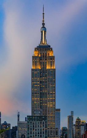 New York, USA - July 29, 2019: Manhattan downtown skyline with illuminated Empire State Building and skyscrapers at sunsetのeditorial素材