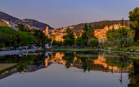Nice, France - June 2, 2019: Reflecting fountain on Promenade du Paillon, surrounded by historic buildings and urban park at Place or Square Massenaのeditorial素材