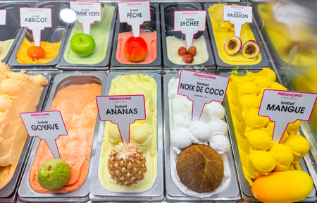 Nice, France - June 02, 2019: World famous artisanal Fenocchio gelato and sorbet display, signs for mango, lychee, guava, coconut flavor ice creamのeditorial素材