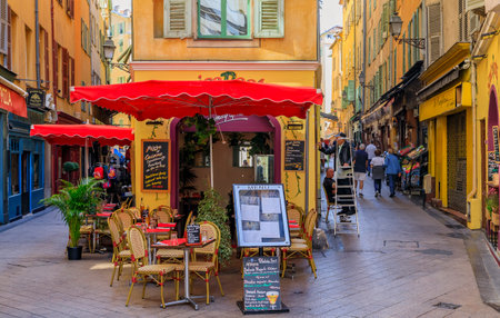 Nice, France - June 2, 2019: Tourists visit the pedestrian zone, commercial and cultural landmark with restaurants and shops in traditional housesのeditorial素材