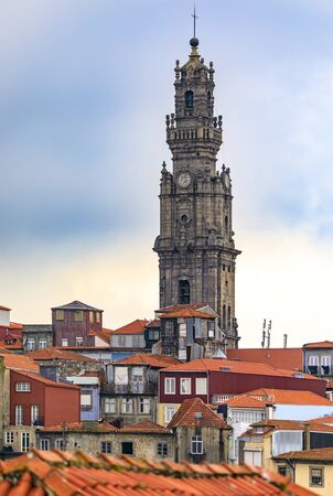 Cityscape with baroque Torre dos Clerigos church bell tower over the terracotta roofs of the old town, one of characteristic symbols of Porto Portugalの写真素材
