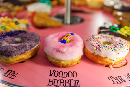 Austin, Texas USA - January 27, 2020: Selection of donuts on display in a colorful case at Voodoo Doughnuts in a popular specialty doughnut chain shopのeditorial素材