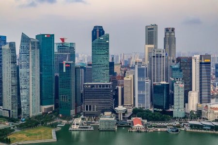 Singapore - September 07, 2019: Famous infinity surf board pool in the Marina Bay Sands luxury hotel and city skyline with skyscrapers at sunriseのeditorial素材