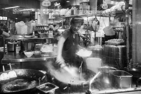 Singapore - September 07, 2019: Smiling street hawker vendor of Chinese stall in Lau Pa Sat, Telok Ayer Market hawker center, black and whiteのeditorial素材