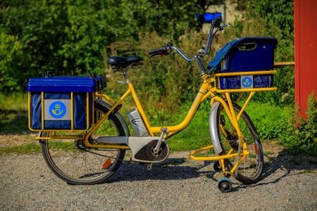 Stockholm, Sweden - August 24, 2017: Traditional Swedish postal service delivery bicycle in the flag colors, blue and yellowのeditorial素材