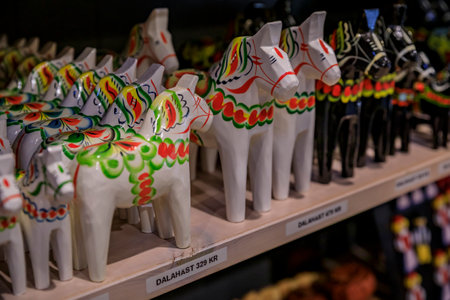 Stockholm, Sweden - August 20, 2017: Traditional hand-made carved and painted dalarna wooden horse souvenir on display at a souvenir shop with price tags saying dala horseのeditorial素材