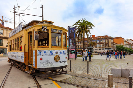 Porto, Portugal - May 30, 2018: View of a typical street in the old town city center with a classic retro tourist tram car and people walking aroundのeditorial素材