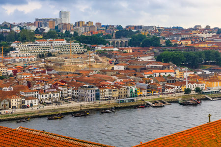 Porto, Portugal - May 29, 2018: View over terracotta roofs across the Douro river onto the famous Portuguese wine cellars in Vila Nova de Gaiaのeditorial素材