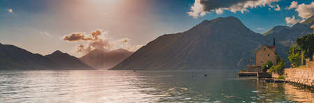 Panorama of Kotor Bay or Boka Kotorska with mountains, crystal clear water and an old stone house in the Balkans, Montenegro on the Adriatic Seaの写真素材