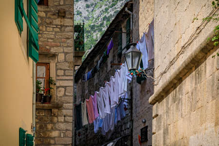 Picturesque narrow streets of the well preserved medieval Old town with laundry drying outside in Kotor, Montenegro in the Balkansの写真素材