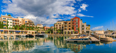 Tivat, Montenegro - May 31, 2019: Scenic view of the Adriatic Sea and luxury residential buildings, shops and boats in the background in the summerのeditorial素材