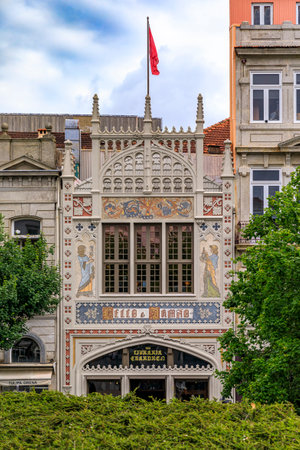 Porto, Portugal - May 30, 2018: Facade of the famous Livraria Lello historic book store decorated with ornate Portuguese azulejo tile mosaic. Inscription says Lello and brother - Book store Chardronのeditorial素材