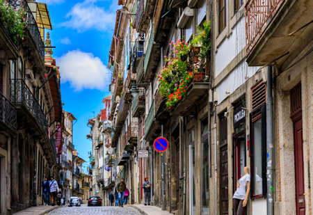 Porto, Portugal - June 1, 2018: Shabby facades and balconies of traditional houses in the old town,...