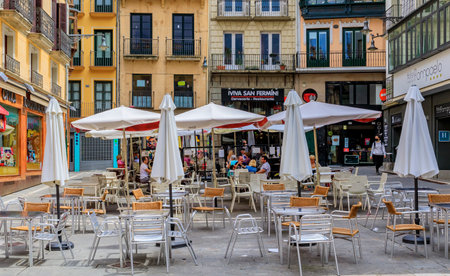 Pamplona, Spain - June 20, 2021: People in street cafes on Plaza Consistorial in the old town or Casco Viejo famous for running of the bullsのeditorial素材