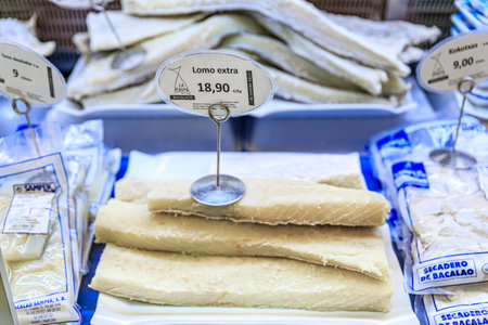 Pamplona, Spain - June 22, 2021: Dried pieces of salted cod or bacalao, traditional Spanish delicacy for sale at a market in the old town, Casco Viejo. The tag says premium fillet, 22 euro a kiloのeditorial素材