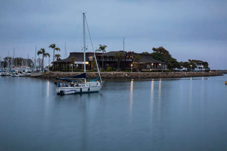 Cloudy sunset over the pier and boats in Dana Point harbor, Orange county in Southern Californiaの写真素材