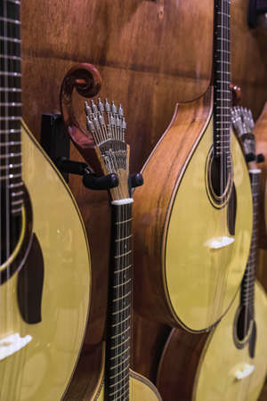 Traditional 12 string acoustic Portuguese guitar or guitarra for sale on display in a musical instrument shop in Porto, Portugalの写真素材