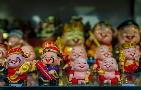 Singapore - September 08, 2019: Selection of porcelain souvenir figurines of the laughing buddha on display at the Chinatown market for saleのeditorial素材