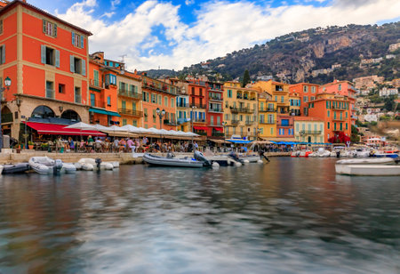 Seaside promenade with colorful houses and boats on the Mediterranean Sea in Villefranche sur Mer Old Town on the French Riviera, South of Franceのeditorial素材