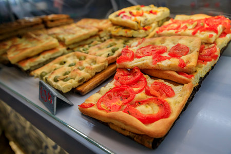 Selection of freshly made focaccia, traditional local flat bread at a restaurant in old town of Manarola in Cinque Terre on Mediterranean Sea, Italyの写真素材